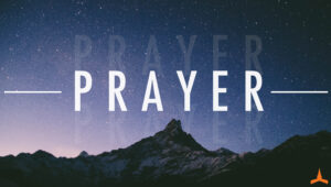 prayer text in white with shadow. over starry mountain range background